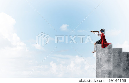 Girl power concept with cute kid guardian against cloudscape background . Mixed media Girl power concept with cute kid guardian against cloudscape background . Mixed media 69166166