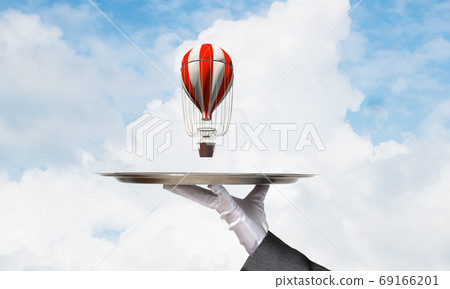 Hand of waiter presenting balloon on tray. Hand of waiter presenting balloon on tray. 69166201