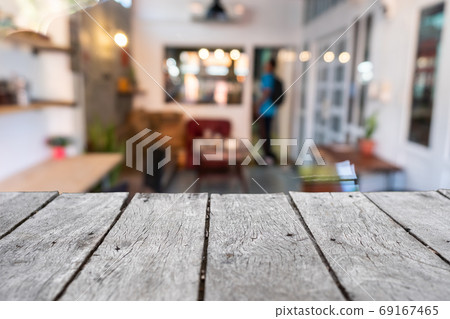 Selective focus of wooden table with blur coffee and restutant cafe with customers. Selective focus of wooden table with blur coffee and restutant cafe with customers. 69167465