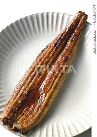 Kabayaki of whole eel on a round plate taken from a white background (overview) 69168474