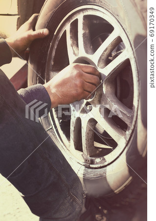 Close up view on wheel repair process vertical Close up view on wheel repair process vertical 69170349