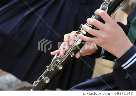 Supple hands of a young woman playing the clarinet Supple hands of a young woman playing the clarinet 69171147