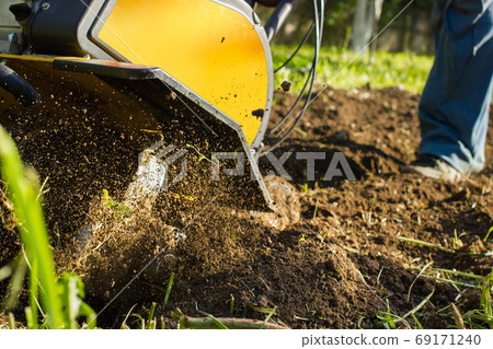 Close up view on fuzzing soil nuggets during motor cultivator plow job Close up view on fuzzing soil nuggets during motor cultivator plow job 69171240