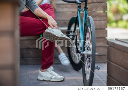 Young man in red pants next to the track bike Young man in red pants next to the track bike 69172167