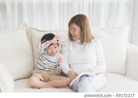 Asian mother Sitting With Son Reading Story Asian mother Sitting With Son Reading Story 69172217