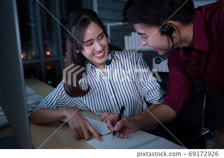 Young Thai Asian customer services care operators working night Young Thai Asian customer services care operators working night 69172926