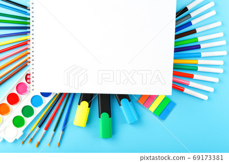 A set of school supplies for learning and creative development on a blue background. 69173381