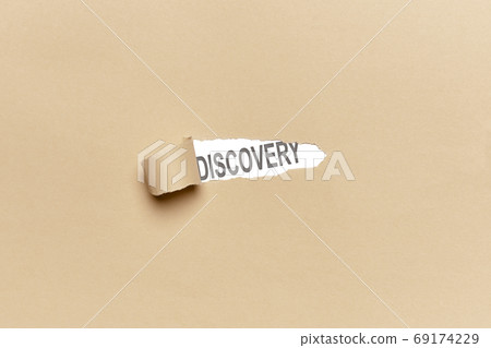 Broken brown wrapping paper with the word DISCOVERY. With copy space 69174229