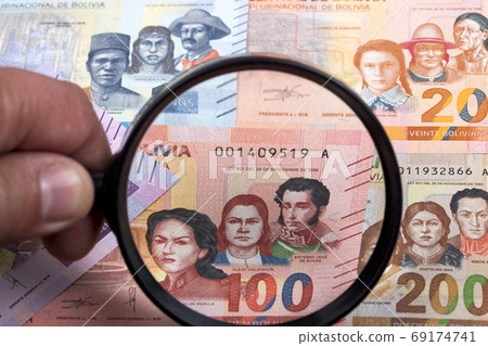 Bolivian money in a magnifying glass  69174741