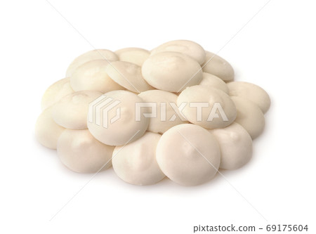 Pile of white chocolate buttons 69175604