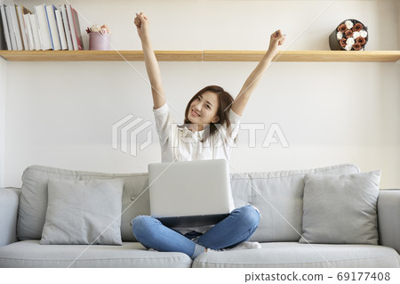 young asian businesswoman working at home using laptop young asian businesswoman working at home using laptop 69177408