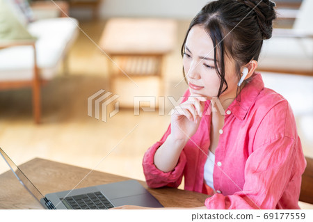 Tired young woman in telework Tired young woman in telework 69177559