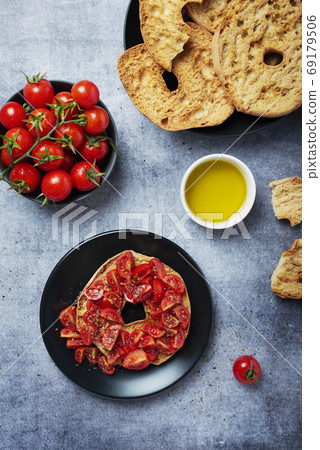 Friselle with tomato, oil and origano Friselle with tomato, oil and origano 69179506