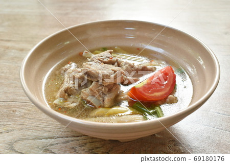 hot and spicy pork bone with mushroom in Thai tom yum soup on bowl hot and spicy pork bone with mushroom in Thai tom yum soup on bowl 69180176