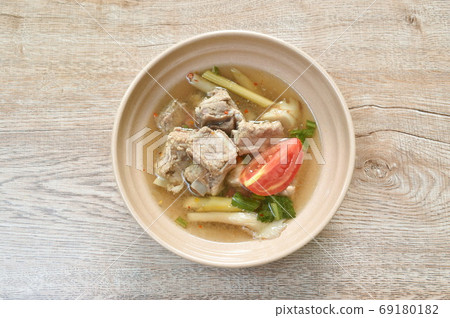 hot and spicy pork bone with mushroom in Thai tom yum soup on bowl  69180182