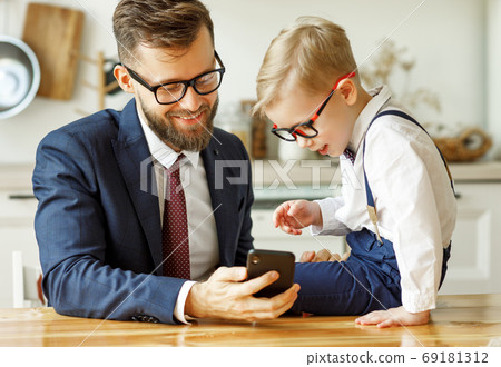businessman father with a young schoolboy son businessman father with a young schoolboy son 69181312