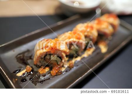 c Topped with orange flying fish roe In a square plate In a japanese restaurant. Selective focus. c Topped with orange flying fish roe In a square plate In a japanese restaurant. Selective focus. 69181611