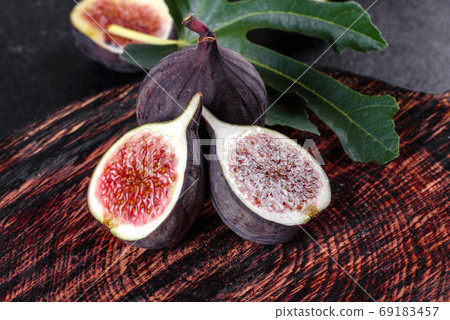 Fresh ripe figs on a dark concrete background. Harvesting figs Fresh ripe figs on a dark concrete background. Harvesting figs 69183457