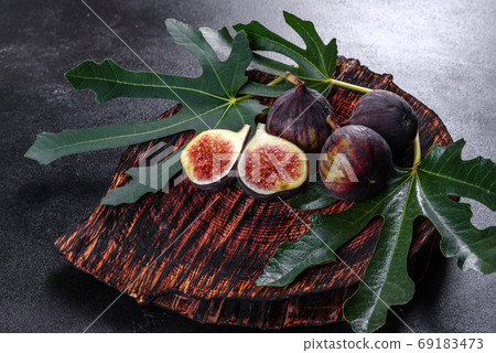 Fresh ripe figs on a dark concrete background. Harvesting figs Fresh ripe figs on a dark concrete background. Harvesting figs 69183473