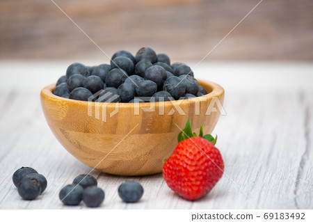 Bio Fruit Blueberry in bowl wood health and diet with vitamin c in close-up on the wood table. 69183492