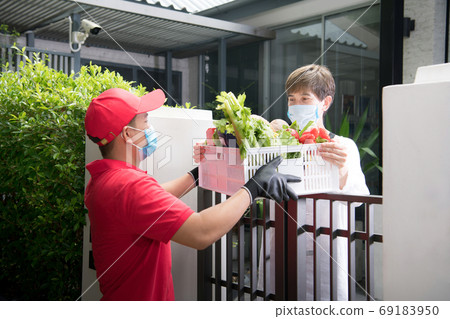 Delivery man with protective mask and gloves delivering parcels