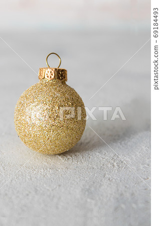 Christmas and New Year composition with golden ball on a white wooden background Christmas and New Year composition with golden ball on a white wooden background 69184493