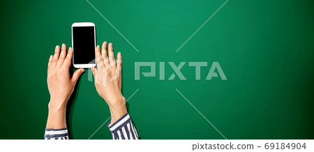 Person using a white smartphone 69184904