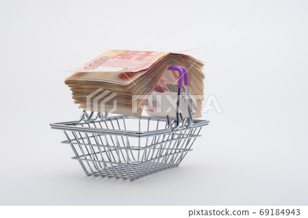 On the handles of the grocery basket is a large bundle of paper Russian five-thousandth bills 69184943