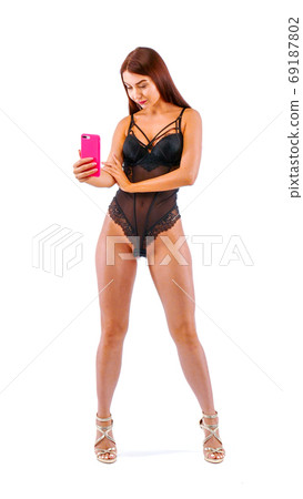 Pretty woman with mobile phone in hands. Pretty woman with mobile phone in hands. 69187802