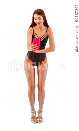 Pretty woman with mobile phone in hands. Pretty woman with mobile phone in hands. 69187803