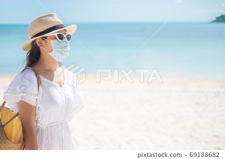 Happy tourist woman wearing surgical face mask  enjoy beautiful 69188682
