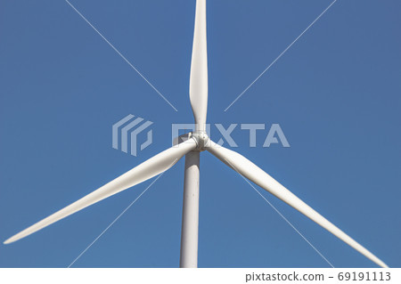 Close up, front view of a wind tower turbine electricity gererator, renewable energy source. Close up, front view of a wind tower turbine electricity gererator, renewable energy source. 69191113