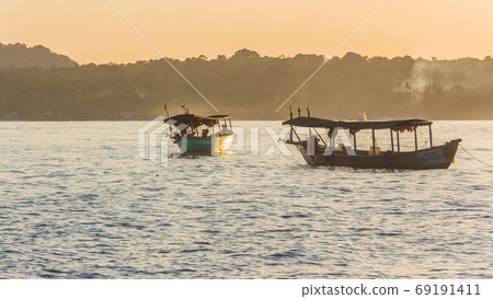 A sunset on Koh Rong island with two boats 69191411