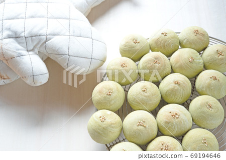 Home made chinese cake (Moon cake), soy bean cake on wire rack with oven mitts on table 69194646