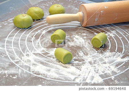 Rolling pin, dough on silicone baking mat.Preparing to asian cookies 69194648
