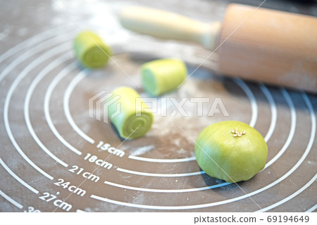 Rolling pin, dough on silicone baking mat. Preparing to asian cookies 69194649