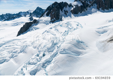 Mountain rock covered with white snow Mountain rock covered with white snow 69194859