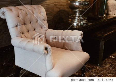beige cushion sofa chair armchair in living room. 69195863