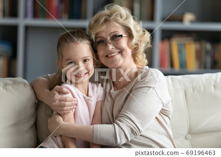 Head shot portrait smiling mature grandmother and pretty granddaughter 69196463