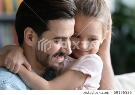 Close up loving young father hugging pretty little daughter 69196526