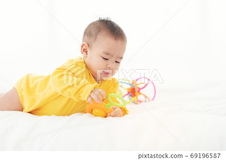 Cute thai newborn baby playing  funny in bed. Small baby in diap 69196587