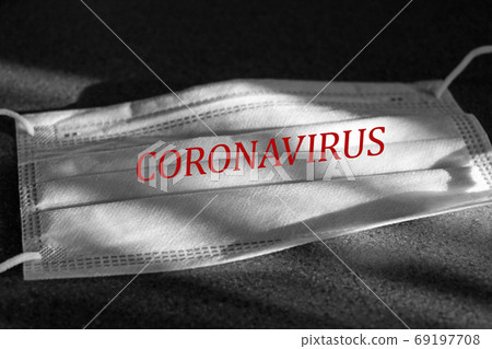 Medical mask with the inscription CORONAVIRUS to fight against COVID - 19. Medical mask with the inscription CORONAVIRUS to fight against COVID - 19. 69197708