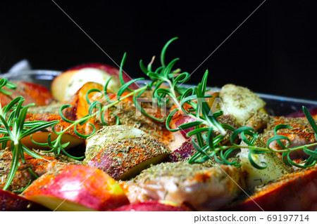 A branch of green rosemary on pieces of meat and apples. A branch of green rosemary on pieces of meat and apples. 69197714