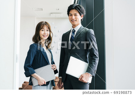 Young male and female business person portrait Young male and female business person portrait 69198873