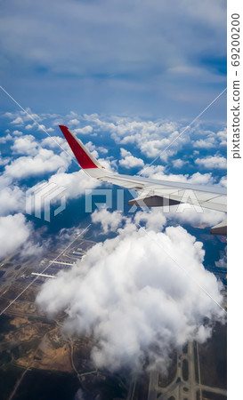 An airplane flying over Kuala Lumpur skies An airplane flying over Kuala Lumpur skies 69200200