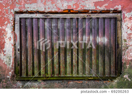 The old grated cellar window in the town house 69200263