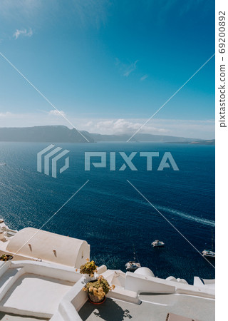 Oia Santorini Greece famous with romantic and beautiful sunsets. Oia village in Santorini island.Greece. 69200892