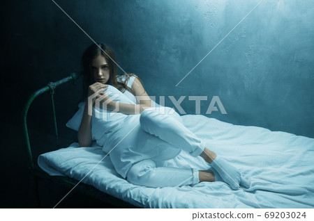 Crazy woman hugs pillow in bed, psychedelic 69203024