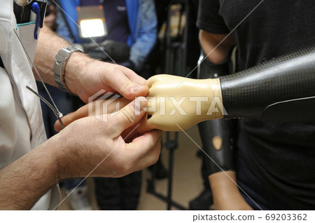 Doctor hands helping disabled man to try an Doctor hands helping disabled man to try an 69203362