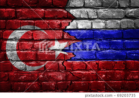 Closeup, flags of Turkey against Russia on a cracked brick wall background. Concept of crisis of war and political conflicts between nations. Closeup, flags of Turkey against Russia on a cracked brick wall background. Concept of crisis of war and political conflicts between nations. 69203735
